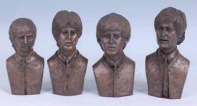 Lot 1187 - The Beatles, a set of four bronzed resin busts,...