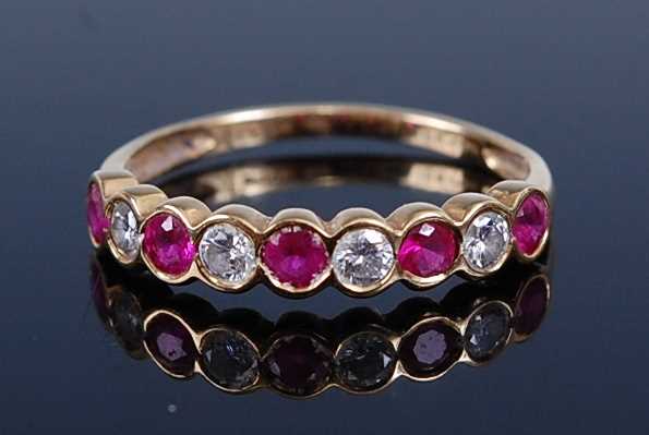 Lot 2221 - An 18ct yellow gold, ruby and diamond half...