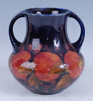Lot 78 - A Moorcroft Pomegranate pattern pottery twin...