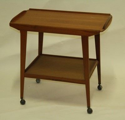 Lot 545 - A 1970s teak two-tier tea trolley, the top...