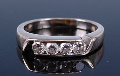 Lot 2174 - A white metal diamond four-stone ring,...
