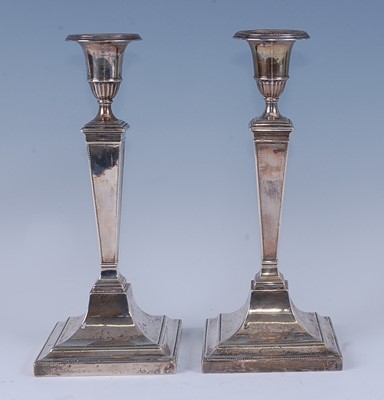 Lot 2150 - A pair of George V silver candlesticks, having...