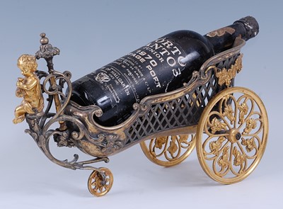 Lot 2306 - An early 20th century gilt metal wine bottle...