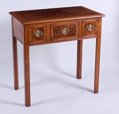 Lot 2513 - A walnut and figured walnut lowboy in the...