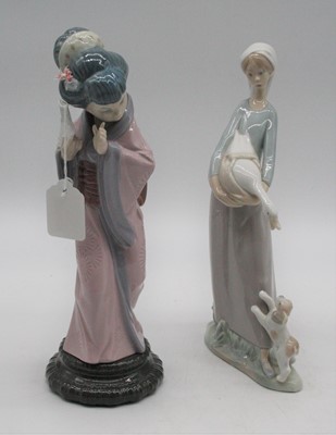 Lot 17 - A Lladro porcelain figure of a woman carrying...