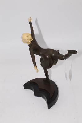 Lot 50 - An Art Deco style bronze and resin figure of a...