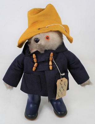 Lot 131 - A child's Paddington bear with yellow hat,...