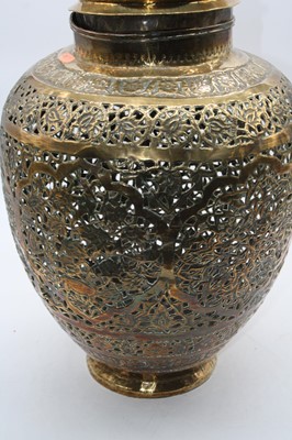Lot 174 - An eastern pierced brass urn, with floral...