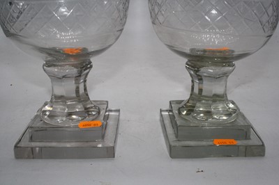 Lot 182 - A pair of cut glass hurricane lamps, each upon...