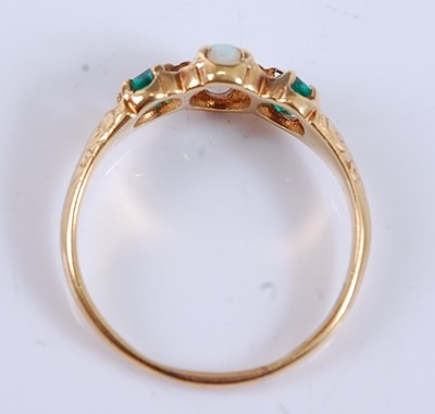 Lot 2534 - A yellow metal, opal and emerald three stone...