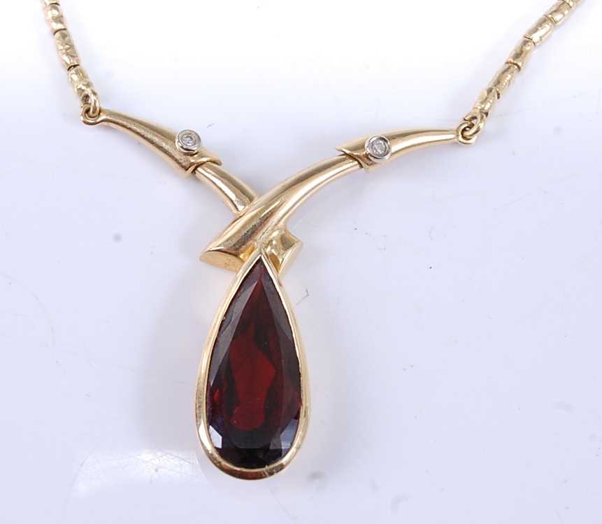 Lot 2525 - A yellow metal, garnet and diamond necklet,...