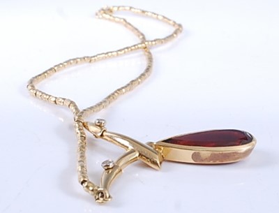 Lot 2525 - A yellow metal, garnet and diamond necklet,...