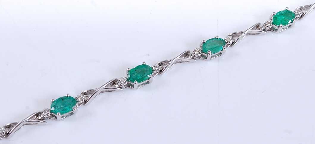 Lot 2531 - A white metal, emerald and diamond line...