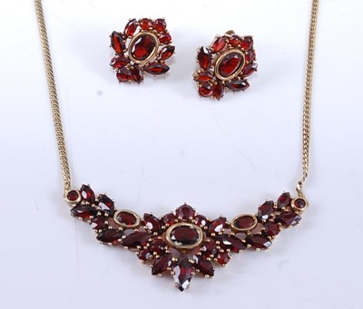 Lot 2535 - A yellow metal garnet necklet and earring...