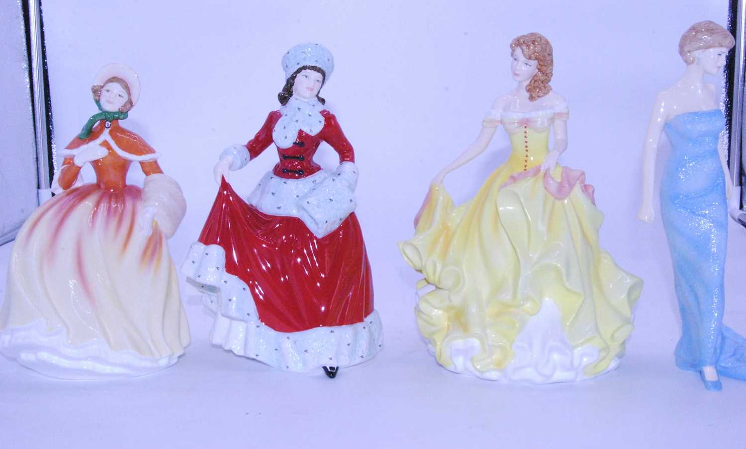 Lot 9 - A collection of four Royal Doulton figures to...