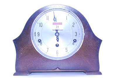 Lot 21 - A 1950s oak cased mantel clock having a...