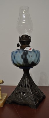 Lot 24 - A late Victorian oil lamp having a blue tinted...