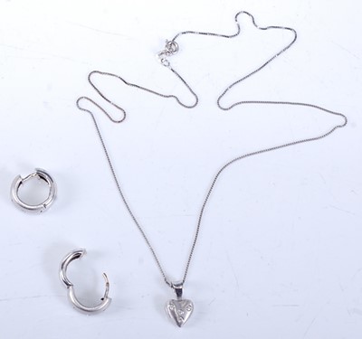 Lot 2537 - A white gold diamond pendant and earring set,...