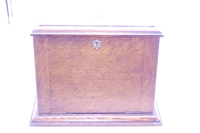 Lot 45 - An Edwardian oak stationery cabinet, having a...