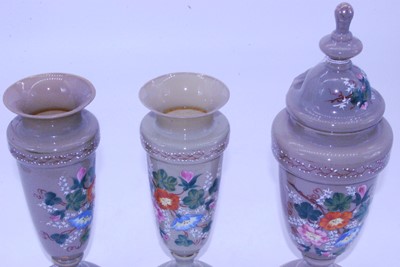 Lot 46 - An early 20th century grey glass garniture urn...