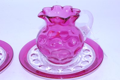 Lot 49 - A Victorian cranberry glass jug, having a...