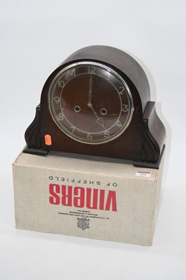 Lot 116 - A 1950s oak cased mantel clock having raised...