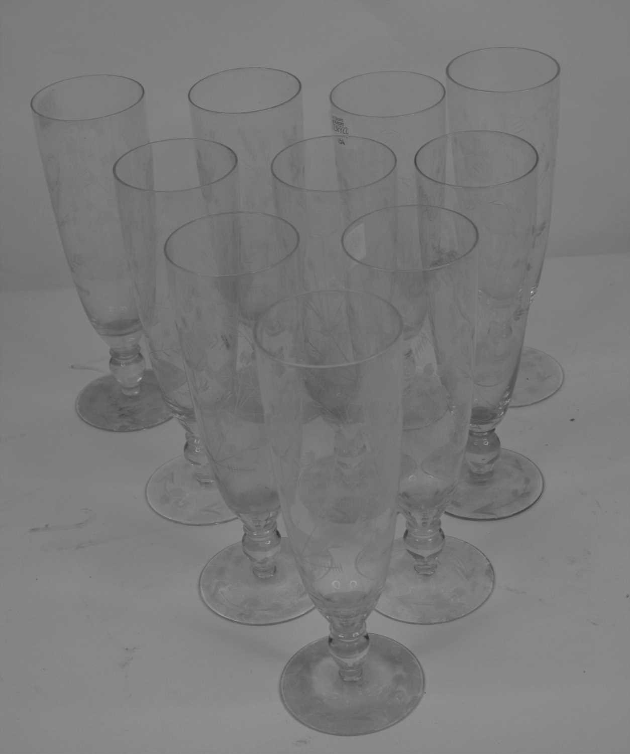 Lot 154 - A set of ten Edwardian glass flutes, each...