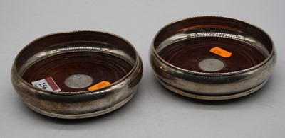 Lot 256 - A pair of modern silver bottle coasters, each...