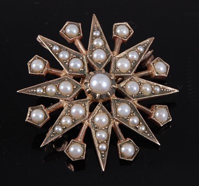Lot 2551 - A 9ct yellow gold pearl eight-ray star brooch,...