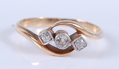 Lot 2558 - A yellow metal diamond crossover style ring,...