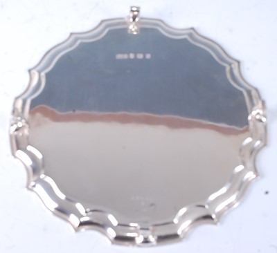 Lot 1104 - A George V silver card waiter, of shaped...
