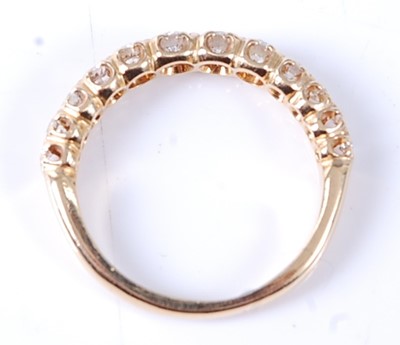 Lot 2569 - A yellow metal diamond half hoop eternity ring,...