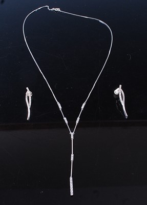 Lot 2574 - An 18ct white gold diamond pendant and earring...