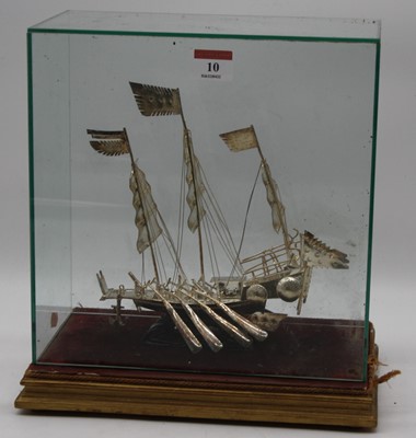 Lot 10 - An eastern white metal model of a junk boat,...