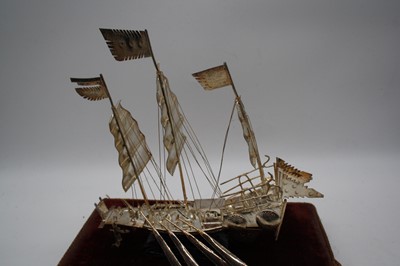 Lot 10 - An eastern white metal model of a junk boat,...