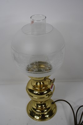 Lot 17 - A late Victorian brass oil lamp (converted)...