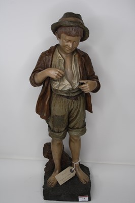 Lot 19 - A continental pottery figure of a boy, height...