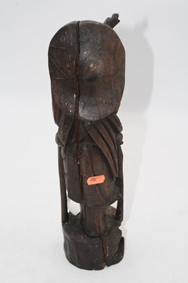 Lot 27 - A Japanese carved hardwood figure of a man,...