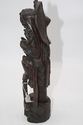 Lot 27 - A Japanese carved hardwood figure of a man,...