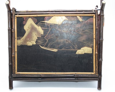 Lot 39 - A Japanese black lacquered and bamboo framed...