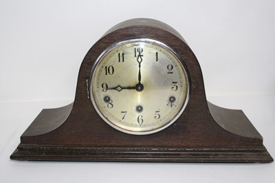 Lot 105 - A 1930s oak cased mantel clock, having a...