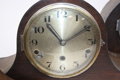 Lot 105 - A 1930s oak cased mantel clock, having a...