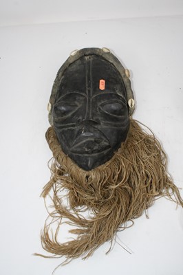 Lot 84 - A West African tribal mask, the elongated face...