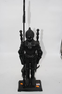 Lot 90 - A cast iron fireside companion set in the form...