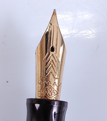 Lot 77 - An Omas Extra fountain pen, of black faceted...