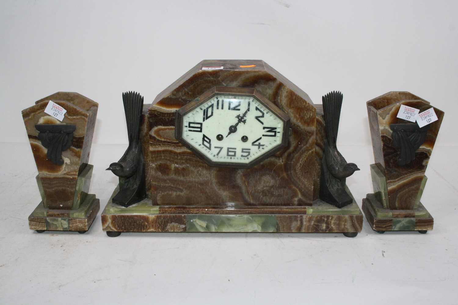 Lot 127 - An Art Deco onyx clock garniture, the central...
