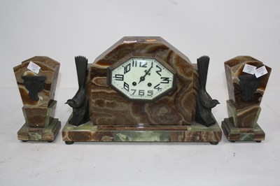 Lot 127 - An Art Deco onyx clock garniture, the central...