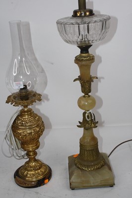 Lot 129 - A Victorian oil lamp having a glass font on an...