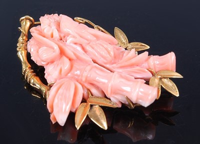 Lot 2594 - A yellow metal carved pink coral brooch,...