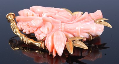 Lot 2594 - A yellow metal carved pink coral brooch,...